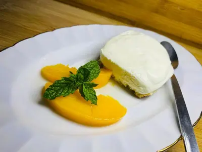a piece of cake on a plate with a piece of fruit at Mrhali Boutique Guest House in Kwamhlanga