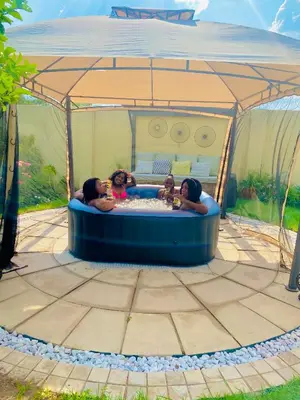 a group of children in a hot tub in a tent at Mrhali Boutique Guest House in Kwamhlanga