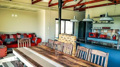 a living room with a table and chairs and a couch at Lodge @ Bankenkloof Private Game Reserve in Tierpoort