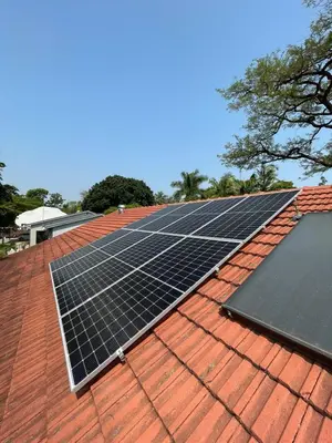 a group of solar panels on top of a roof at Plum Cottage in Nelspruit
