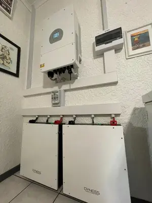 a machine on a wall next to two refrigerators at Plum Cottage in Nelspruit