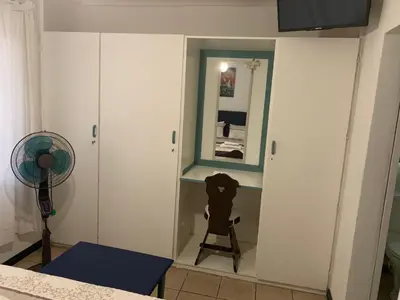 a room with a mirror and a dog on a tripod at Plum Cottage in Nelspruit