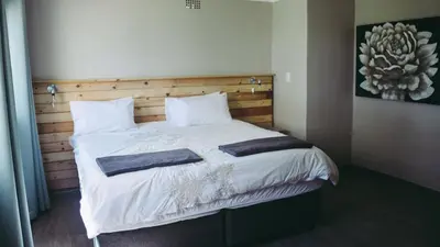 a bedroom with a bed with two towels on it at Buffalo House @Bankenkloof Private Game Reserve in Tierpoort