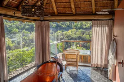 a bathroom with a tub and a large window at Sediba Luxury Safari Lodge in Welgevonden Game Reserve