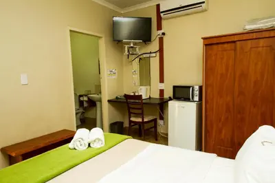 a hotel room with a bed with two towels at @ Marula in Mokopane