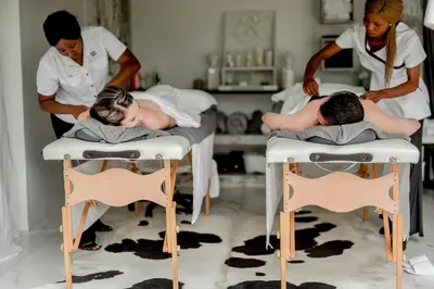 a couple of people laying in beds in a room at Moditlo River Lodge in Hoedspruit