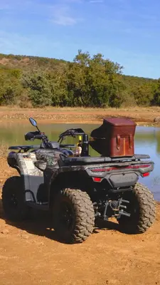 an atv parked next to a body of water at Mologa River Lodge in Rust de Winter