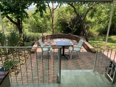 a table and chairs sitting on a brick patio at Tranquil Nest in Hazyview
