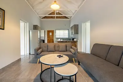 a living room with a couch and a table at Tranquil Nest in Hazyview