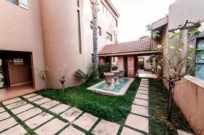 a courtyard of a house with a garden at Château La Mer Exclusive Guesthouse & Spa in Hartbeespoort