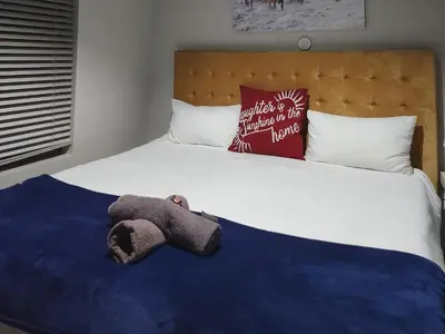 a stuffed animal is laying on a bed at Kosmos, Hartbeespoort in Hartbeespoort