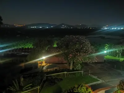 a view of a house at night with lights at Kosmos, Hartbeespoort in Hartbeespoort