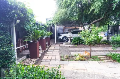 a cat laying on the ground in a garden at Snooze-A-Lot Guesthouse in Secunda