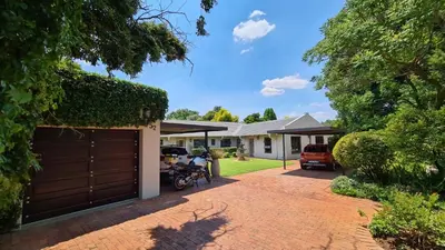 a house with a garage and a driveway at Jasmine Guest Cottage in Benoni