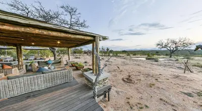 a wooden deck with a pavilion in the desert at Imagine Africa Luxury Tented Camp in Balule Game Reserve