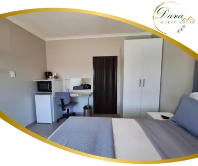 a bedroom with a bed and a desk with a computer at Dara on Schabort street in Trichardt