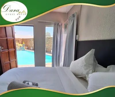 a bedroom with a bed and a view of a pool at Dara on Schabort street in Trichardt