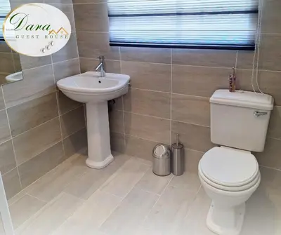 a bathroom with a toilet and a sink at Dara on Schabort street in Trichardt