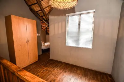 a room with a staircase and a window and a door at Khiza Bush Retreat in Hoedspruit