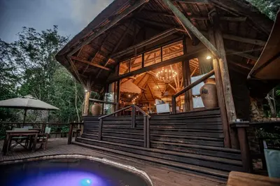 a house with a pool in front of it at Tanamera Lodge in Hazyview