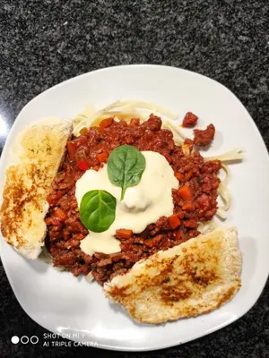 a plate of food with chili and a piece of bread at Charis View Guest House in Belfast
