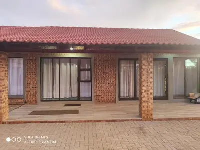 a small house with a patio in front of it at Charis View Guest House in Belfast