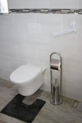 a white toilet in a bathroom with a sink at Charis View Guest House in Belfast