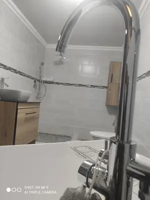 a kitchen with a sink and a light over a counter at Charis View Guest House in Belfast