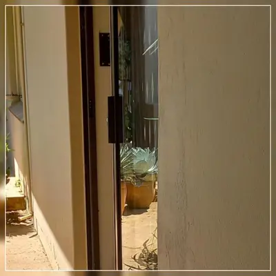 an open door of a house with a potted plant at A-Cody Place in Louis Trichardt