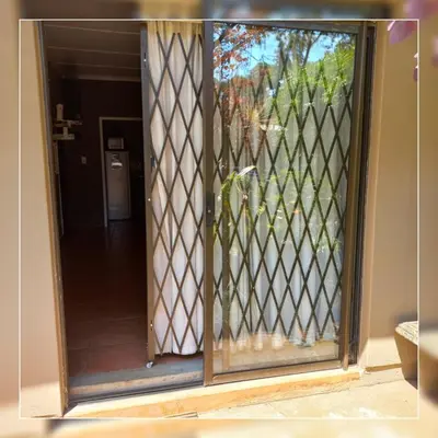 a sliding glass door with a view of a yard at A-Cody Place in Louis Trichardt
