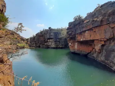 a river between two large rocky cliffs at Riverbed Africa in Lydenburg