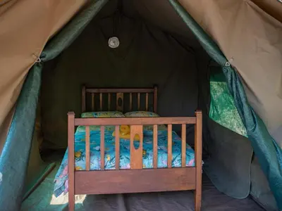 a small bed in a tent at Riverbed Africa in Lydenburg
