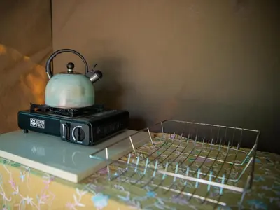 a tea kettle sitting on top of a toaster oven at Riverbed Africa in Lydenburg