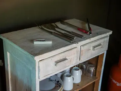 a wooden table with utensils on top of it at Riverbed Africa in Lydenburg