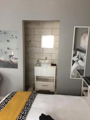 a bathroom with a sink and a mirror at B&B 464 on 22nd Ave in Pretoria