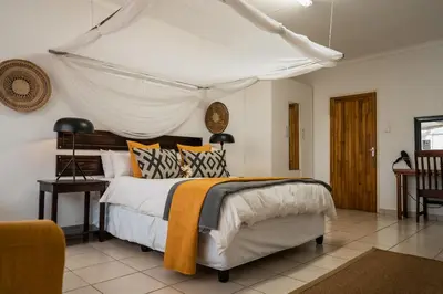 a bedroom with a bed with a canopy at Tshukudu Game Lodge in Hoedspruit