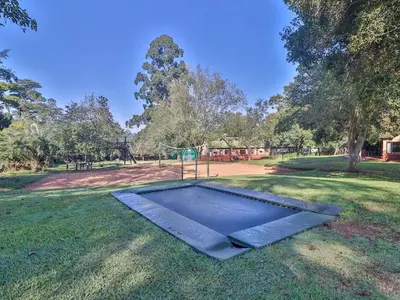 a trampoline in the grass in a park at FamilyQuest Accommodation in White River
