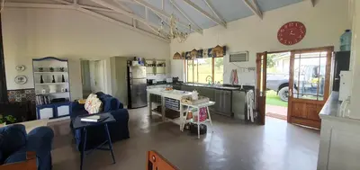 a room with a kitchen and a living room at Riverside Farm in Witbank