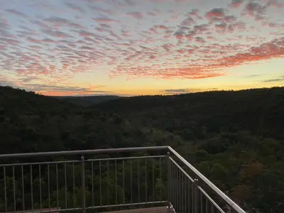 a view of a sunset from a viewing deck at Elements Bush Lodge in Moheme