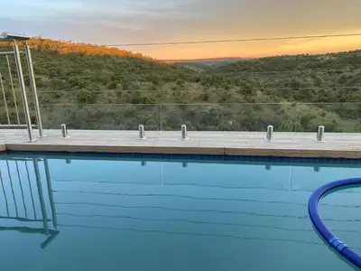 a swimming pool with a view of a mountain at Elements Bush Lodge in Moheme