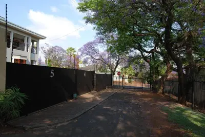 a black fence in front of a house at Muckleneuk Guest House in Pretoria