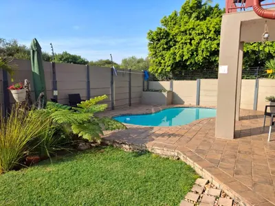 a backyard with a swimming pool and a fence at Christa's Place 897 in Pretoria