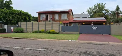 a house on the side of a street with a fence at Christa's Place 897 in Pretoria