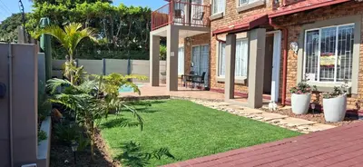 a yard with grass and plants in front of a house at Christa's Place 897 in Pretoria