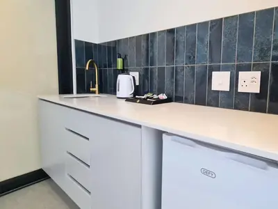 a kitchen with a white counter and a sink at MINT Resorts The Blyde in Pretoria