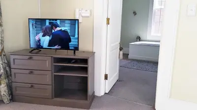 a television sitting on a dresser in a bathroom at Versailles in Pretoria