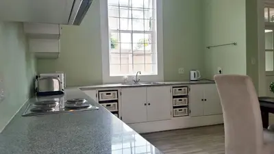 a kitchen with a counter and a sink and a window at Versailles in Pretoria