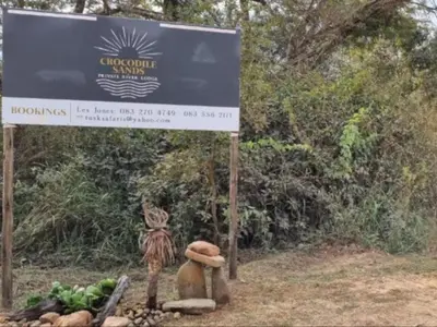 a sign in front of a sign with fruits and vegetables at Crocodile Sands River Lodge in Nelspruit