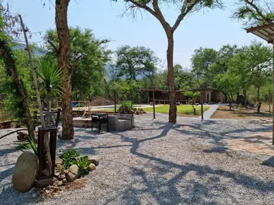 a park with trees and a picnic table at Crocodile Sands River Lodge in Nelspruit