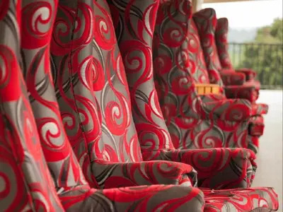a row of red chairs lined up in a row at Ivory Tusk Lodge in Tzaneen